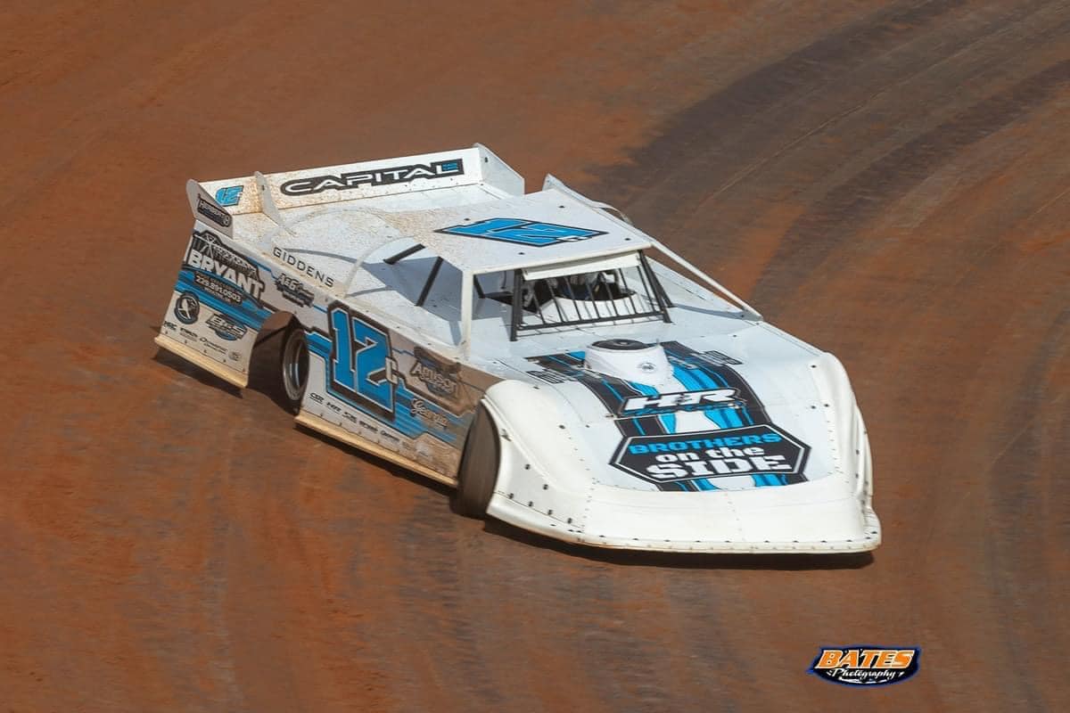 Sprint car with custom Herbert Graphics neon wrap in the shop